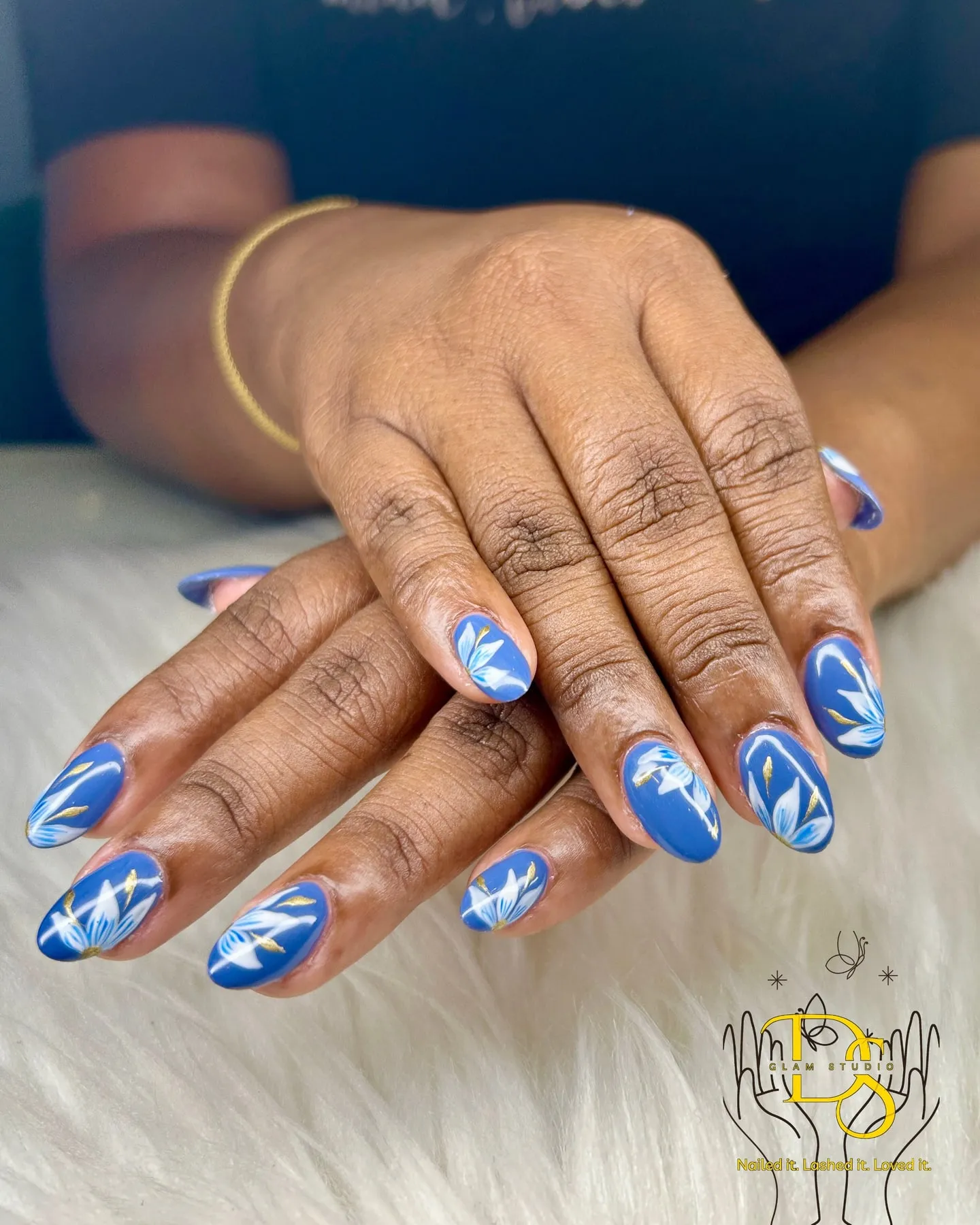 Blue floral nail art on almond nails